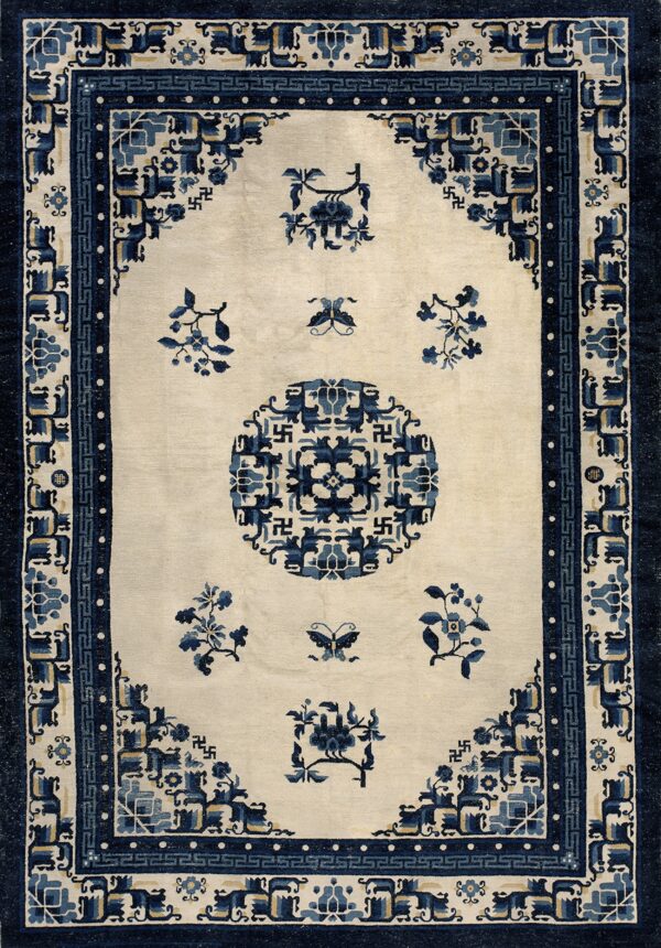 Off-white rug featuring navy and light blue geometric borders and stylized floral patterns.