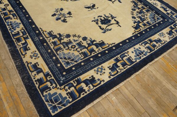 Cream and blue rug featuring scattered flowers, butterflies, and a detailed border on aged wood planks.