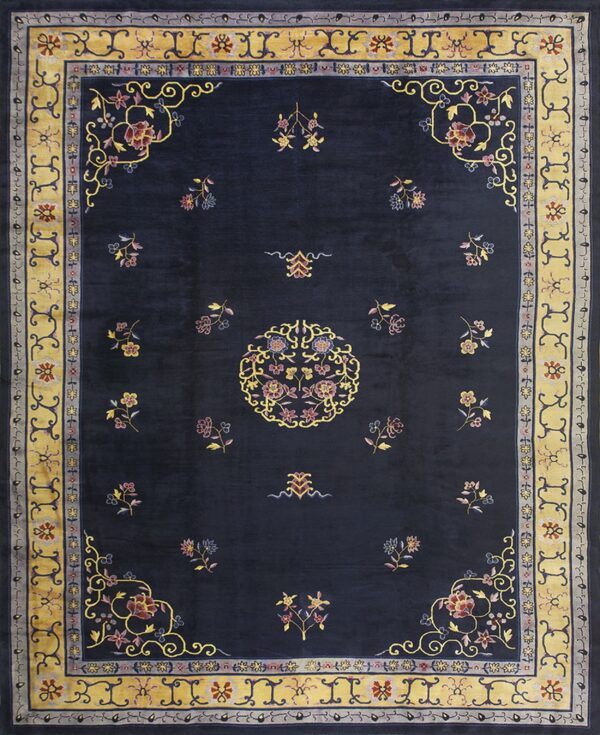 Navy blue rug featuring colorful scattered florals, a central medallion, and wide gold decorative borders.