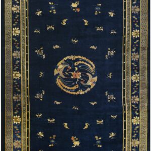 Navy blue rug with a circular gold avian medallion and scattered florals surrounded by ornate Greek key borders.