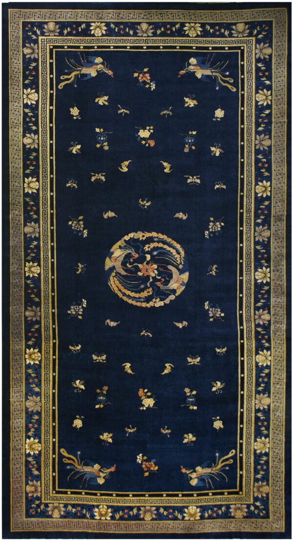Navy blue rug with a circular gold avian medallion and scattered florals surrounded by ornate greek key borders.