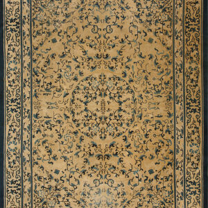 Gold rug with complex dark blue scrollwork and a central medallion, framed by wide navy borders.