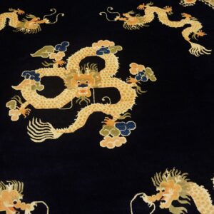 Vibrant gold dragon pattern and multicolored clouds against a velvety dark blue rug background.