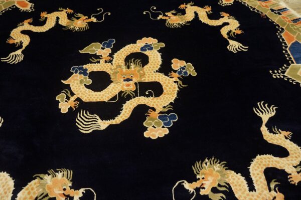 Vibrant gold dragon pattern and multicolored clouds against a velvety dark blue rug background.