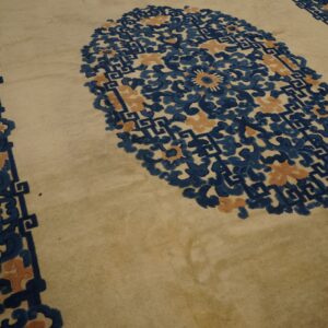 Cream rug with complex indigo and apricot floral medallion and scrollwork borders.