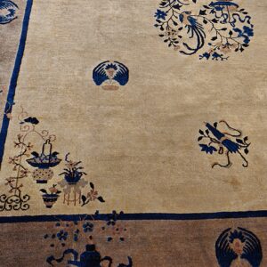 Beige rug field with intricate blue and brown botanical patterns framed by a dark brown outer border.