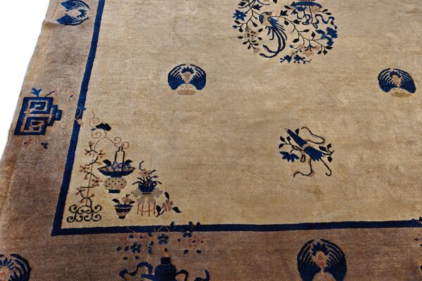 Beige rug field with intricate blue and brown botanical patterns framed by a dark brown outer border.