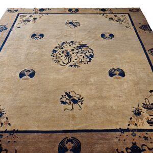 Beige field rug featuring a central blue bird motif, surrounded by vases, flowers, and fans within thick borders.