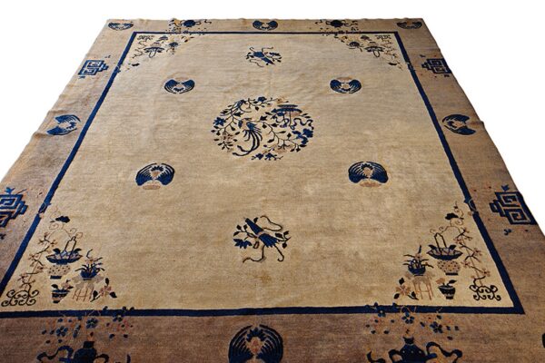 Beige field rug featuring a central blue bird motif, surrounded by vases, flowers, and fans within thick borders.