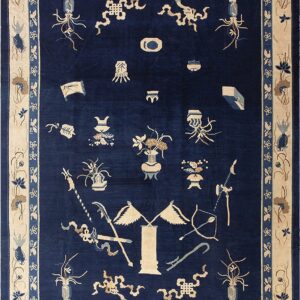 Navy blue rug featuring scattered light emblems, surrounded by a broad floral cream and blue border.