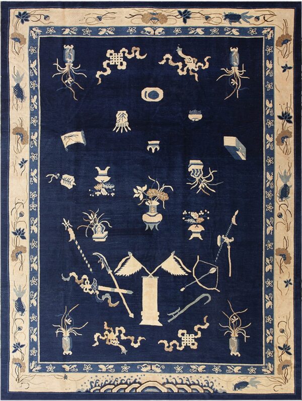 Navy blue rug featuring scattered light emblems, surrounded by a broad floral cream and blue border.