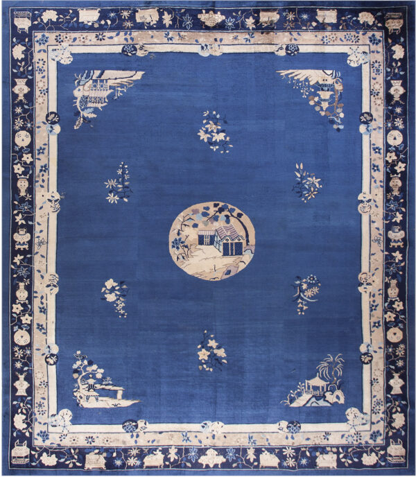 Deep blue rug featuring a central house scene, scattered florals, and wide decorative pictorial borders.