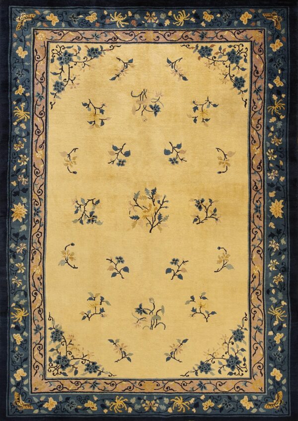 A pale yellow rug featuring scattered blue and gold floral sprays and a wide dark blue border.