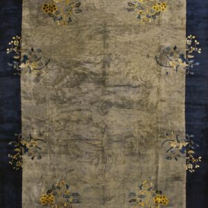 Rug with a muted gray field and navy border decorated with stylized gold and blue floral corner sprays.