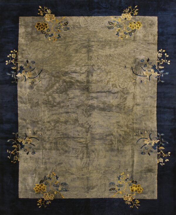 Rug with a muted gray field and navy border decorated with stylized gold and blue floral corner sprays.