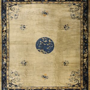 Khaki field rug with extensive navy borders and a large circular medallion depicting birds on flowering trees.