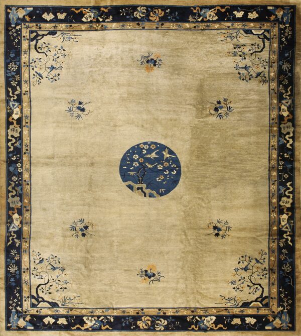 Khaki field rug with extensive navy borders and a large circular medallion depicting birds on flowering trees.