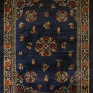 Navy blue rug featuring detailed gold and red floral medallions and an elaborate multi-layered border.
