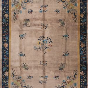Taupe rug with scattered floral motifs and a dark blue border featuring yellow and multicolored flowers.