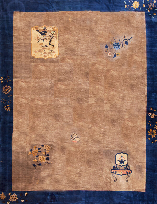 Tan rug with a wide blue border displaying gold floral vines and isolated pictorial motifs in the field.