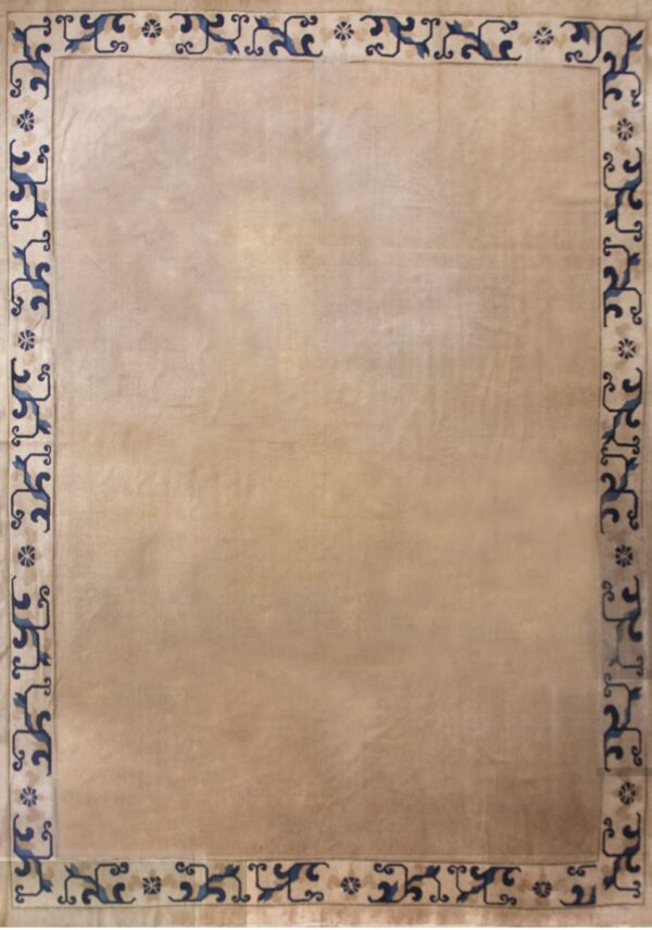 Beige rug with subtle sheen and a full border of stylized blue scrollwork and medallions.