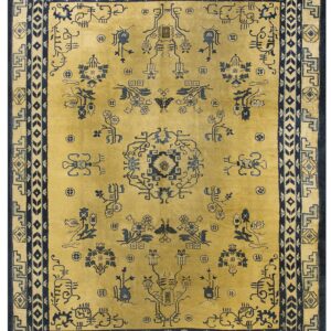 A gold field rug features elaborate dark blue geometric and stylized figurative patterns and borders.