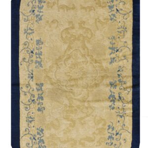 Oval gold and navy rug with subtle carved texture and light blue floral vine designs.