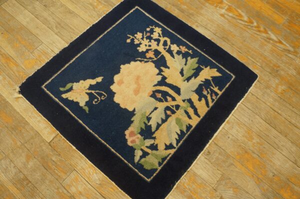 Antique peking square small scatter size wool black & navy rug 5 Navy square rug with a central beige and green floral motif on diagonal wooden planks.