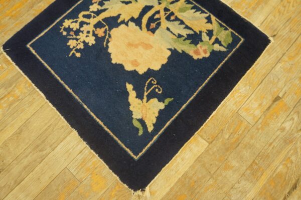 Antique peking square small scatter size wool black & navy rug 3 Navy blue square rug corner featuring large cream and green floral designs on light distressed wood floorboards.