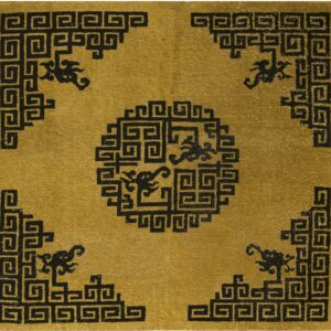 Low-pile rug with a gold field and a black meander pattern forming a medallion and corner designs.