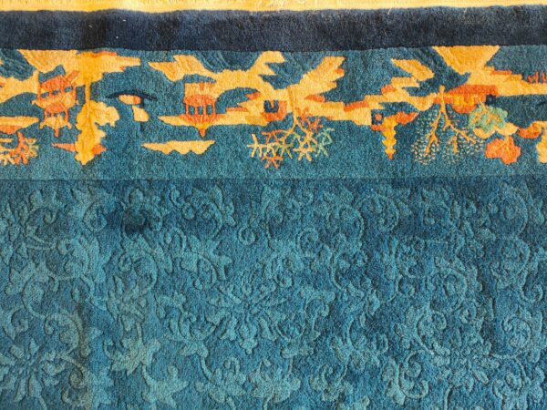 Antique peking small scatter size wool blue, green rug 6 Teal rug detail showing a carved floral field and a high-contrast orange and gold border design.
