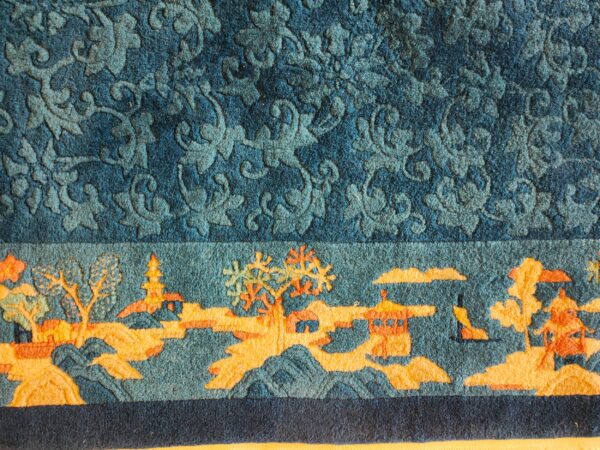 Antique peking small scatter size wool blue, green rug 4 Textured blue rug with a carved floral field above an orange and blue scenic landscape border.