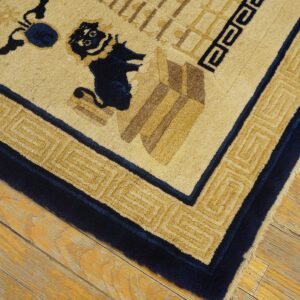 Close-up of a high-pile cream and navy rug with geometric patterns on aged wood flooring.