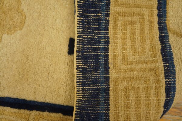 Tan rug detail contrasting shaggy high pile, dark blue lines, and geometric flatweave textures.