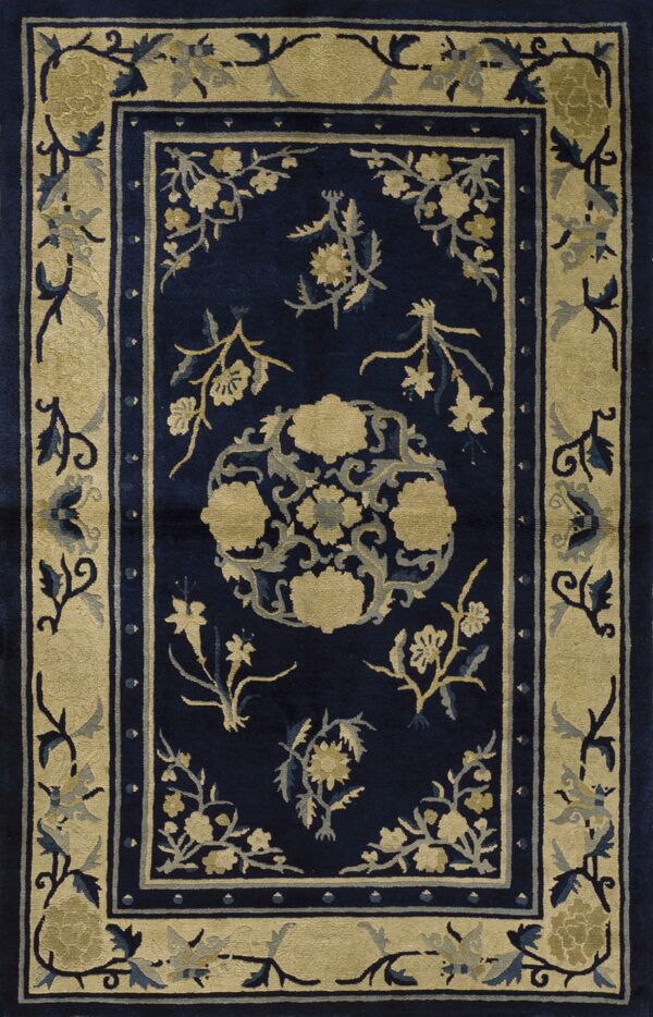 Navy blue rug with a wide beige border and central medallion in a detailed floral pattern.