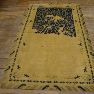 Sculpted yellow rug with navy blue cloud designs and figural borders rests on rustic wood flooring.