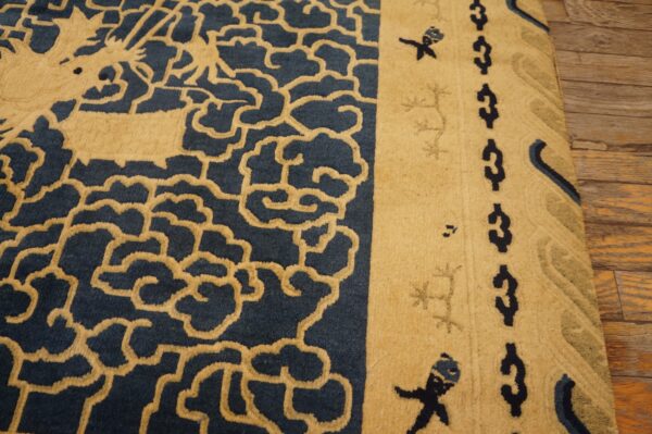 Sculpted high-pile rug in tan and navy blue with cloud patterns rests on distressed wooden floorboards.