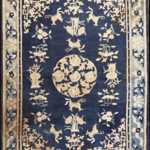 Indigo blue rug featuring complex beige floral and animal designs within ornate, multi-banded borders.