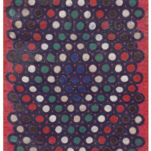 Textured rug with colorful circles—red, white, green, brown—on a navy field, surrounded by a red border.