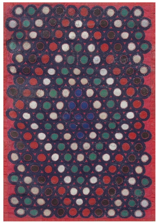 Textured rug with colorful circles—red, white, green, brown—on a navy field, surrounded by a red border.