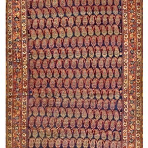 Dark rug with dense rows of reddish paisley motifs, a deep blue field, and wide ornate rust borders.