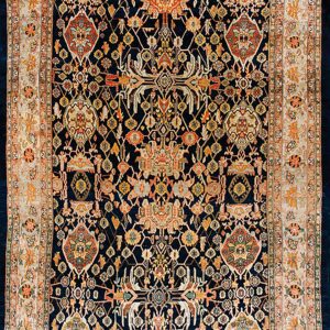 Traditional dark blue rug with dense multicolored patterns, featuring wide cream and orange floral borders.