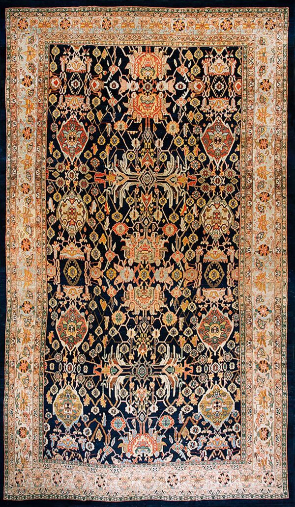 Traditional dark blue rug with dense multicolored patterns, featuring wide cream and orange floral borders.
