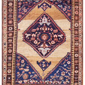 Tan rug with a large navy blue geometric medallion and multiple dark brown and blue borders.
