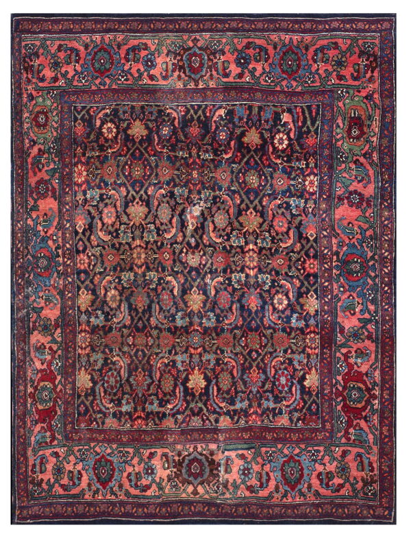 Traditional dark blue rug with intricate floral patterns and a striking wide salmon pink border.