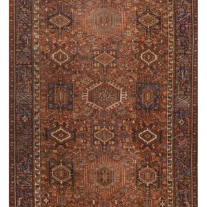 Vertical runner rug with a dense, repeating geometric tribal pattern in rich rust, dark blue, and cream colors.