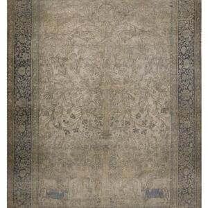 Detailed beige rug featuring a Tree of Life design and a wide, contrasting dark blue floral border.