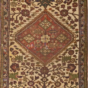 Ivory rug featuring a central rust diamond medallion surrounded by multicolored geometric and stylized floral patterns.