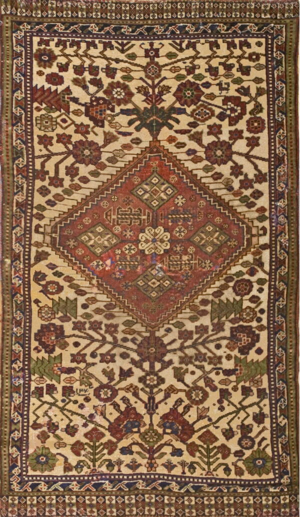 Ivory rug featuring a central rust diamond medallion surrounded by multicolored geometric and stylized floral patterns.