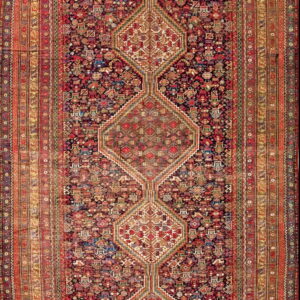 Dense red and navy runner rug with three interconnected geometric medallions and wide, detailed borders.